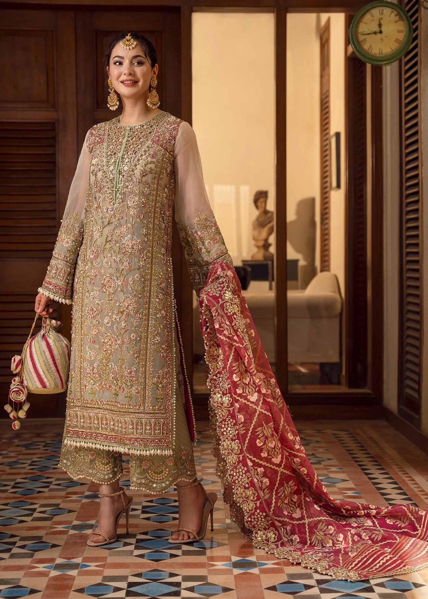 Artisanal Anecdotes Pakistani fashion outfit in gold, pink tones.